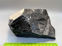 a black rock with a glassy surface appearance